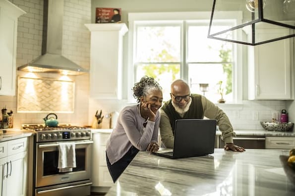 Elderly couple studying a DevOps roadmap and thinking about a career change