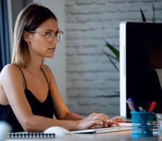 person using a desktop computer in an office