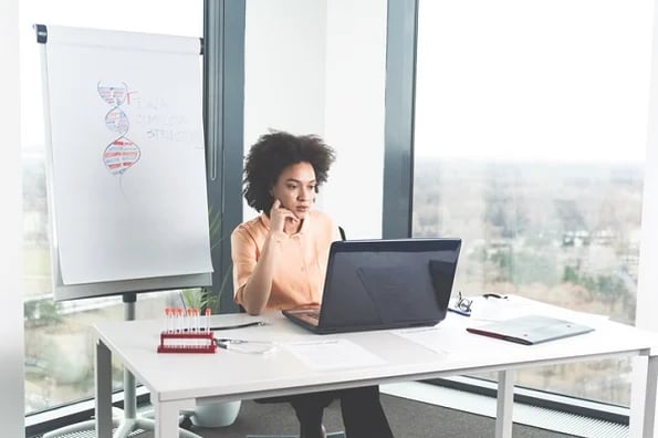 Woman studying the differences between Bootstrap and Tailwind.