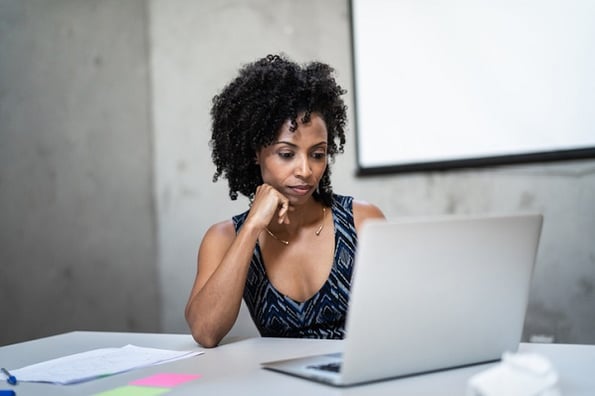 Woman studying online courses and learning about CSS Normalize files.