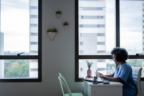 Young woman working on her computer to study the benefits of the JavaScript toUppercase function and how it can help improve the quality of her code.