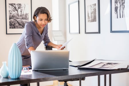 woman looking at museum websites on a computer in an office