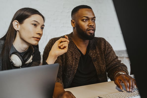 two people doing api versioning in an office on computers