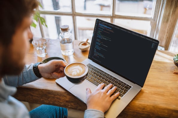 person using file handling in python for work at a coffee shop