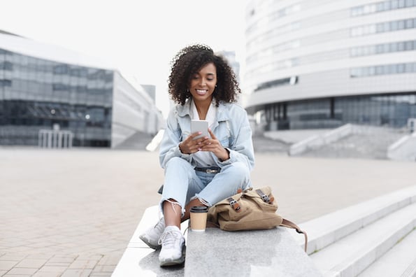 person using a smartphone outside and enjoying the mobile experience