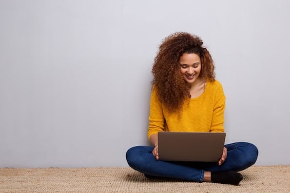 person visiting an orange website on a laptop