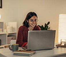 person using a laptop and smiling