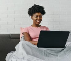 person using a laptop on a couch