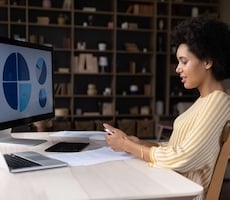 woman viewing graphs on a computer