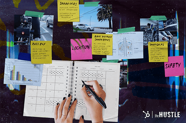 How Many Startups Fail: A pair of hands writes over a calendar surrounded by sticky notes with writing on them.