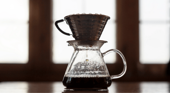 funnel filtering coffee into a pot