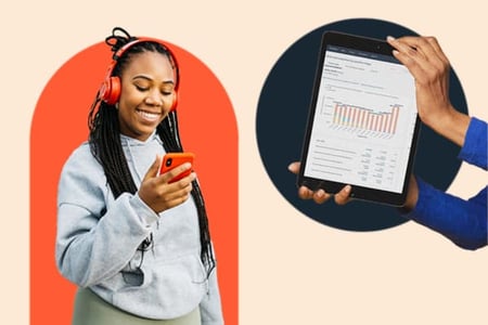 A woman scrolls through facebook on her smartphone while wearing headphones. A person nearby holds up a tablet showing graphs and statistics