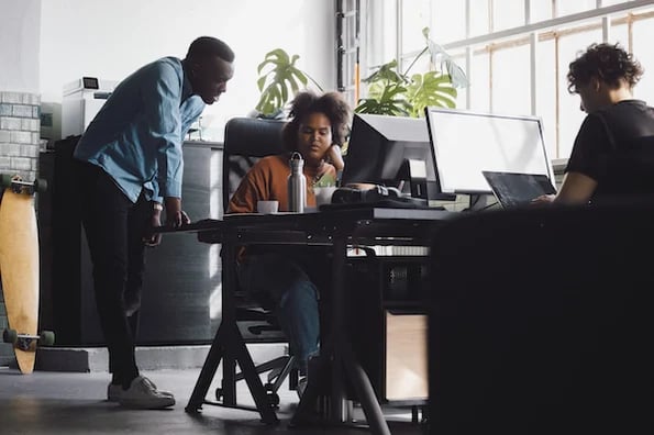 two developers creating a sandbox environment on a computer in an office