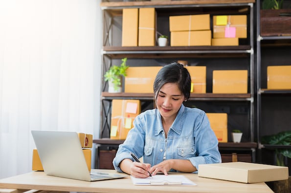 Woman checking inventory of her online store