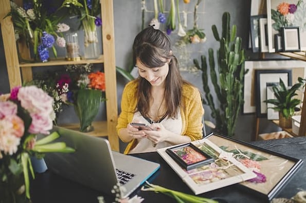 Woman smiling while browsing a website powered by a WordPress membership plugin