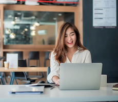 person using a laptop and smiling