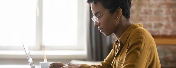 person using a laptop at a desk