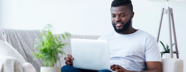 man using a laptop on a couch