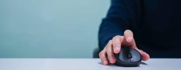 close-up of a hand using a computer mouse