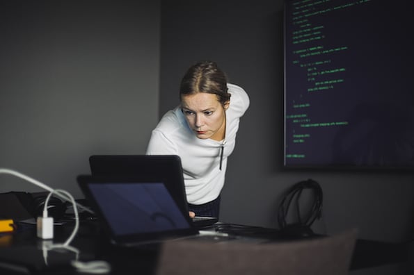 person using an api design tool on a laptop in an office