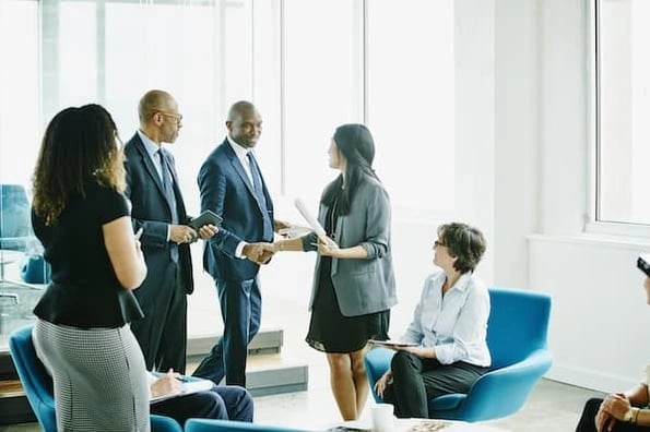 sales team shaking hands after discussing B2B sales process