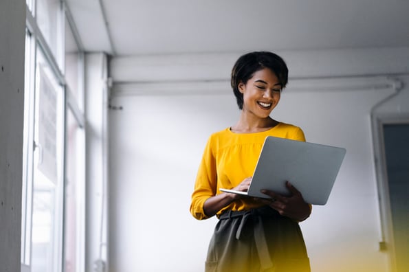 Person smiling at computer at wide selection of resume website templates 