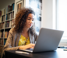 person using a laptop in a library