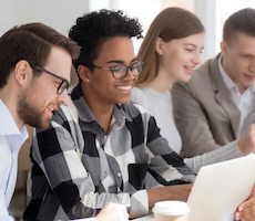 group of people using a laptop in an conference room