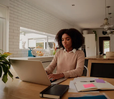 person using a laptop computer at a table