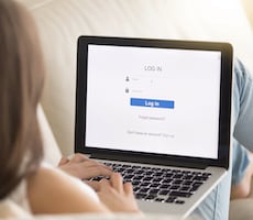 person using a laptop on a couch