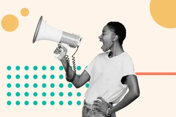 A woman smiles and yells through a megaphone.