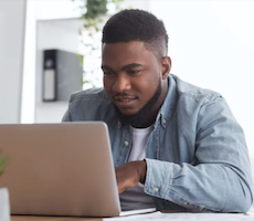 person using a laptop at a table