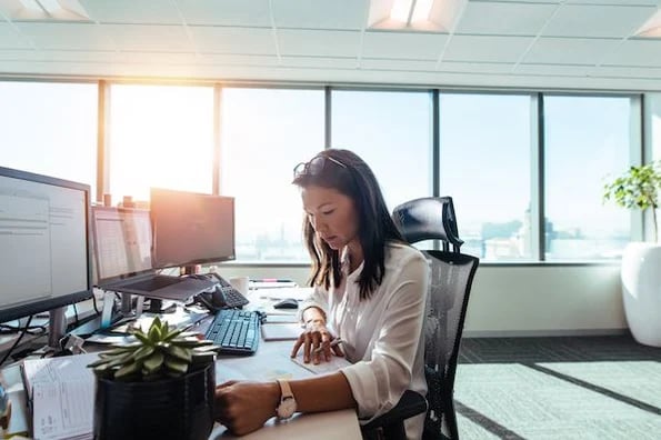 sales person at desk reviewing 'close file' email template