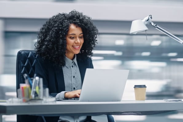 Person at their desk in an office installing Cloudflare WordPress plugin to their company site. 