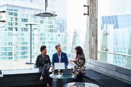 consulting networking discussion at an event over beers