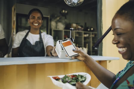 Customer using contactless payment to buy food