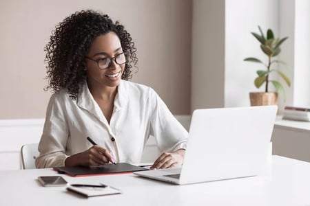 marketer on laptop researching crm resources