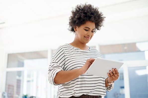 A marketer checks her CRM tool on her iPad.