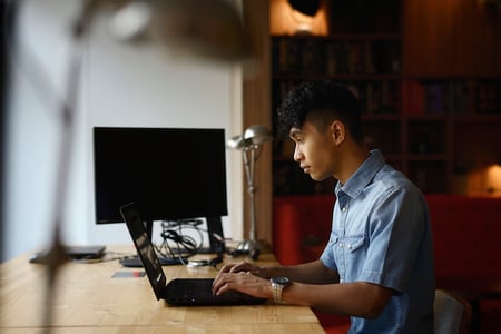 person using CSS animation delay on a laptop in an office