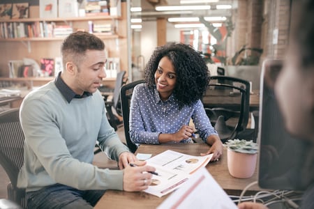 two members of a CX team analyzing customer experience research findings