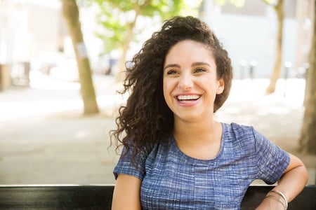 happy customer sitting on a bench after visiting a store