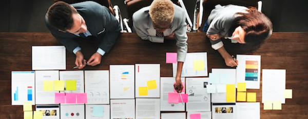 people discussing notes at a conference table