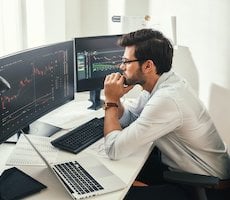 man using a computer to view a chart