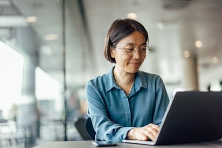 Person on their computer in office looking up data strategy. 