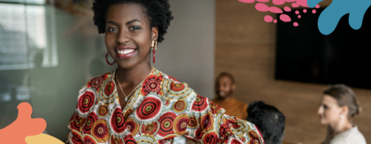 A black business leader smiles after receiving tips from a fellow entrepreneur