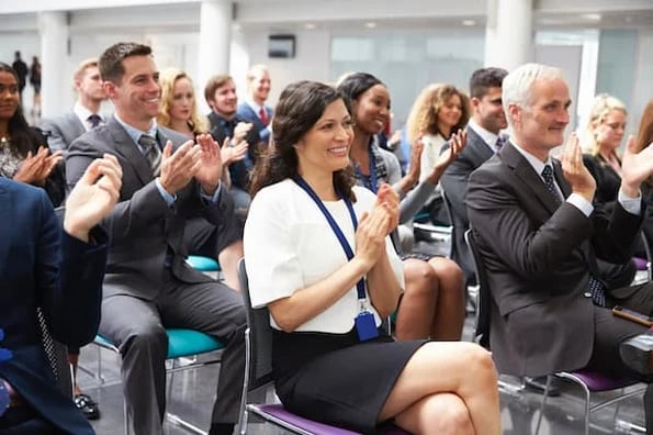 conference attendees applauding