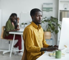 person using a desktop computer in an office