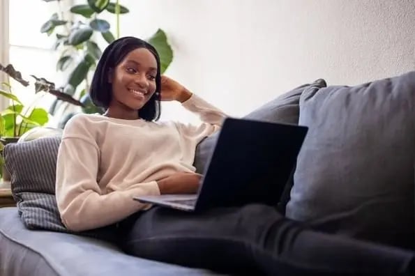 Email personalization makes checking email fun for this woman relaxing on the couch.