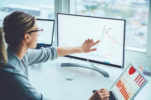 person using an enterprise content management system on a computer in an office