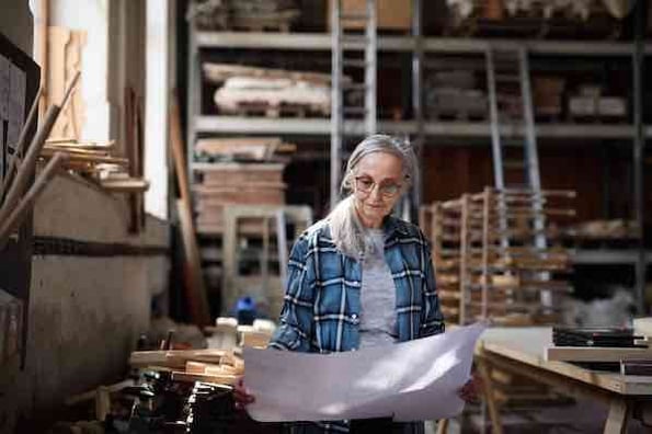 entrepreneurship versus employment, a woman in a woodshop who has chosen entrepreneurship